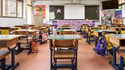 classroom set up with individual desks and colorful classroom decor