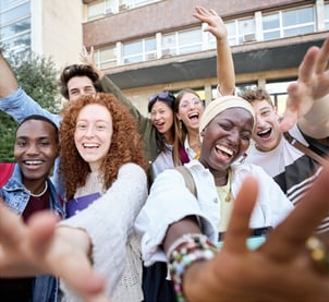 Students cheering outside a school.