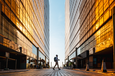 Person walking between two buildings
