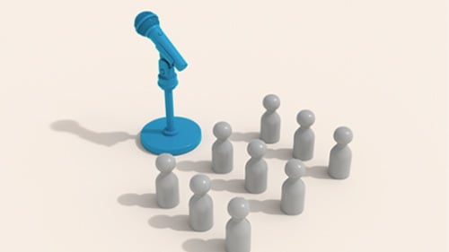 plastic pieces in a group standing toward a microphone