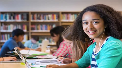 girl on laptop in school library