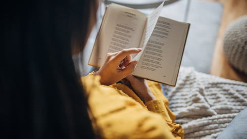 girl reads from poetry book