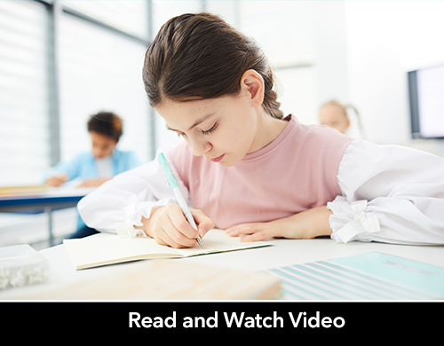 Middle school girl writes on paper