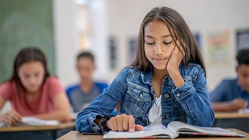 Middle school girl reading book
