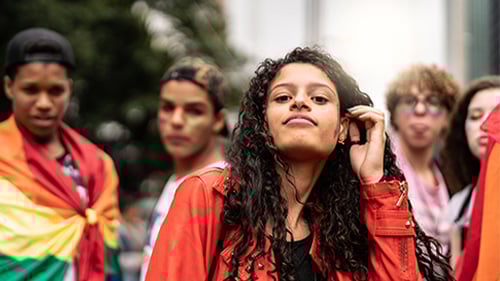 teenagers dressed in pride gear and looking at camera