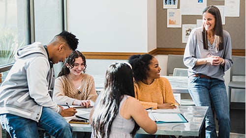 teacher talking with high school students 