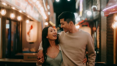 young couple walking through street together