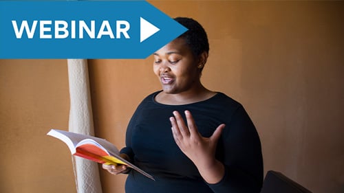 High school student reading poetry from a book