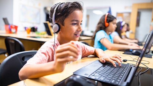 Student on laptop wearing headphones