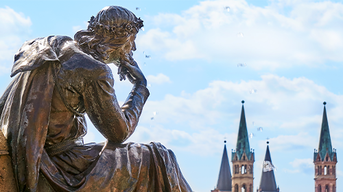 Thinker statue looking over city