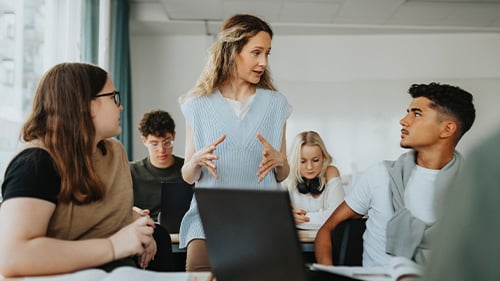 Teacher explaining concept to high school students