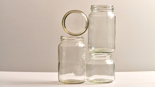 4 empty glass jars stacked on each other