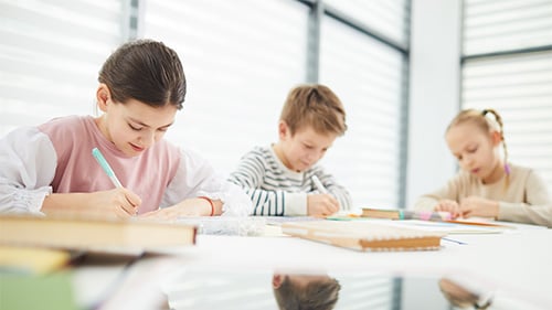 Middle Schoolers working at their desks in a classroom