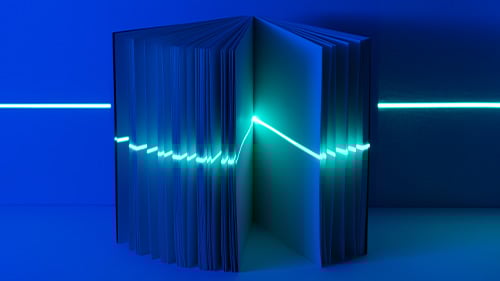 Light Blue lazer runs through book against dark blue background