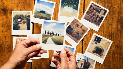 polaroid pictures sitting on wood slats