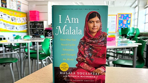 book cover of I am Malala with classroom in the background