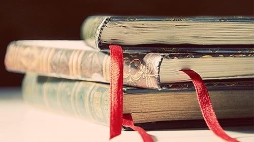 Three old books stacked on each other