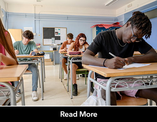 High school students in a classroom focusing on a multiple-choice exam