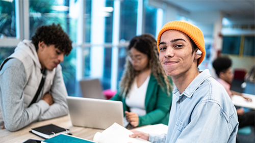 high school students working at a desk 