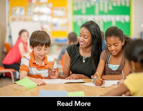 Teacher helping bi-litearte middle school students