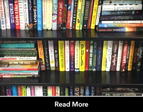 Text: Read More; Image: Classroom library, stacks of books
